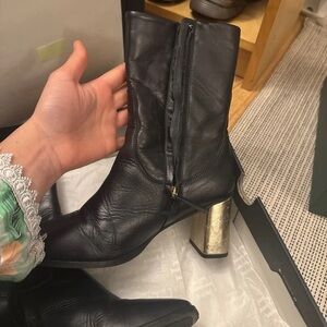 Chic Black Leather Heeled Boots with Gold Accent